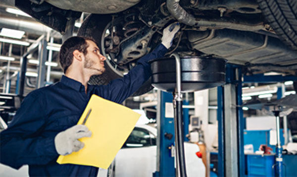 Mechanic checking a car on a lift